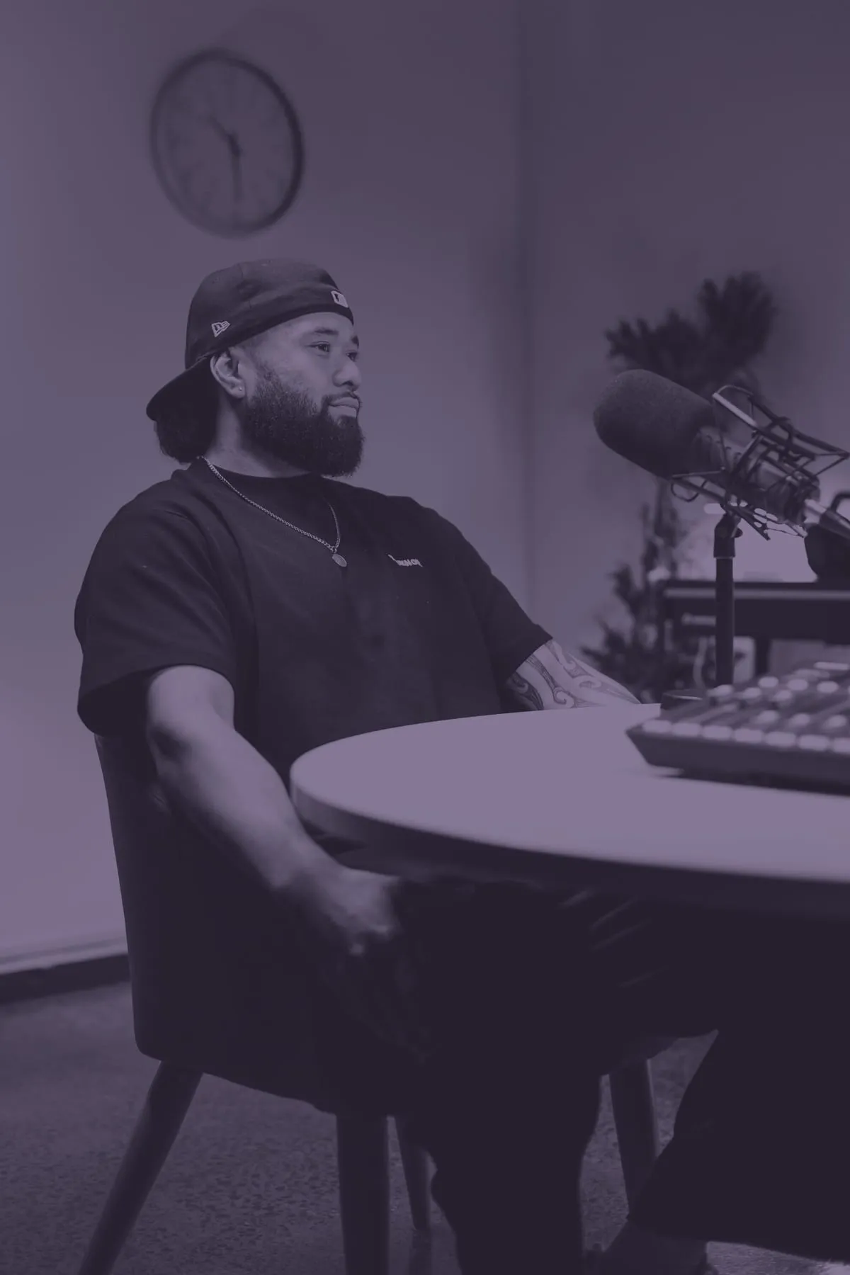 Montel Tivoli seated at the studio table, composed, mic beside him.